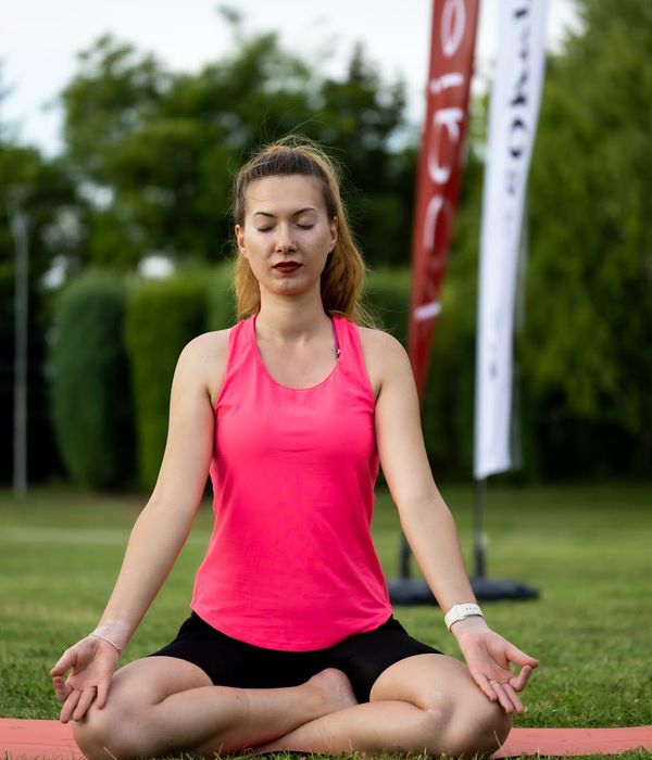 Woman in a calm yoga pose, embodying inner balance and focus.